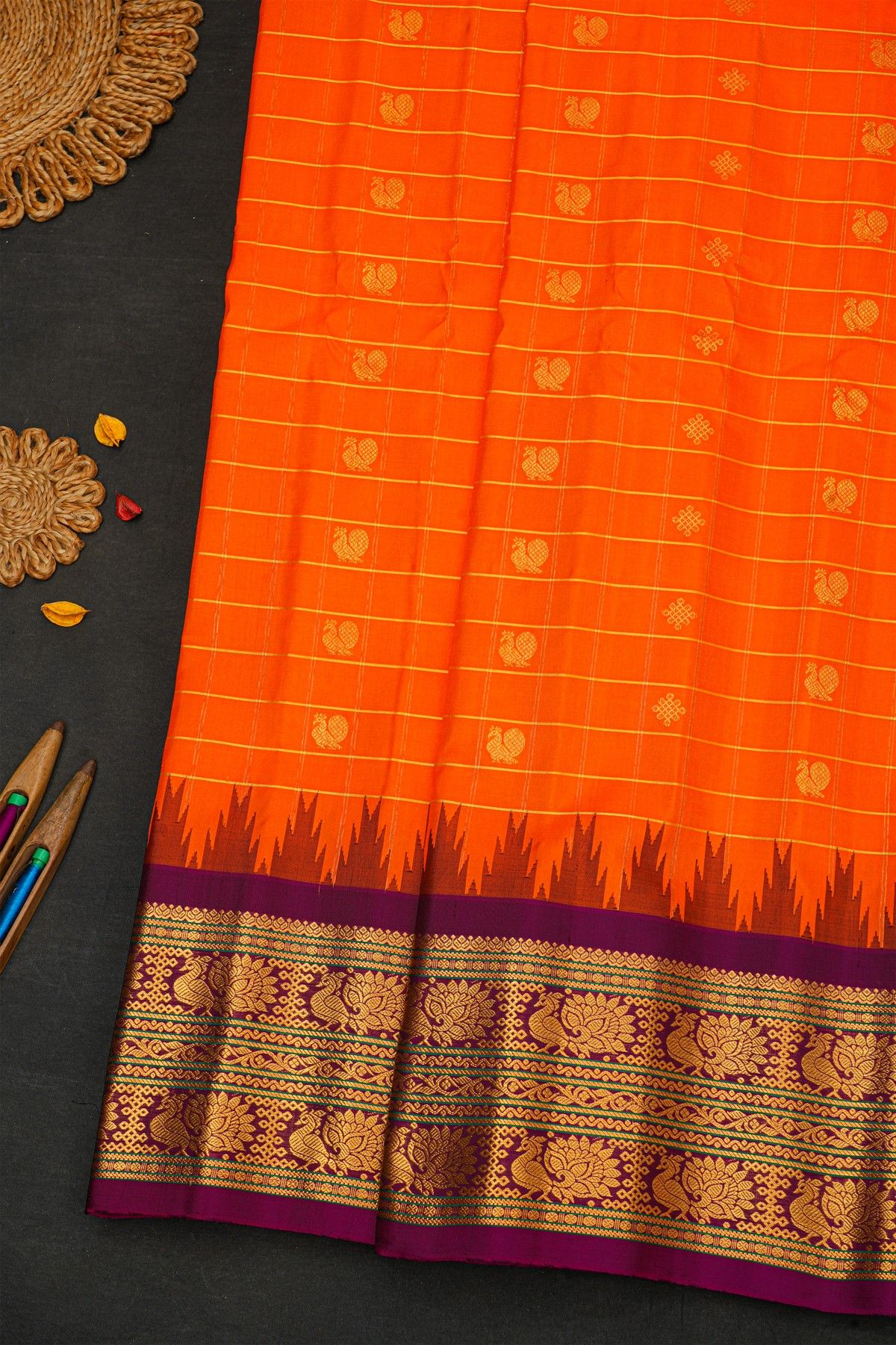 Gadwal Silk Orange Saree With Florals And Peacocks Border