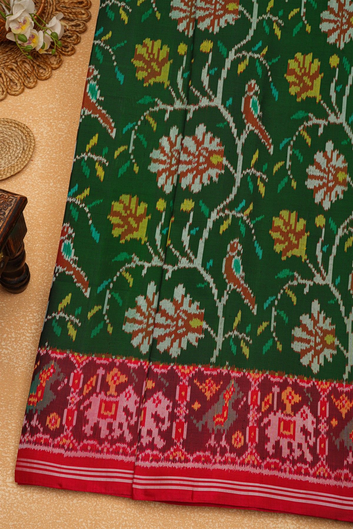 Patola Silk Parrot Green Saree With Florals And Leaves Body And Contrast Florals And Leaves With Animals Border