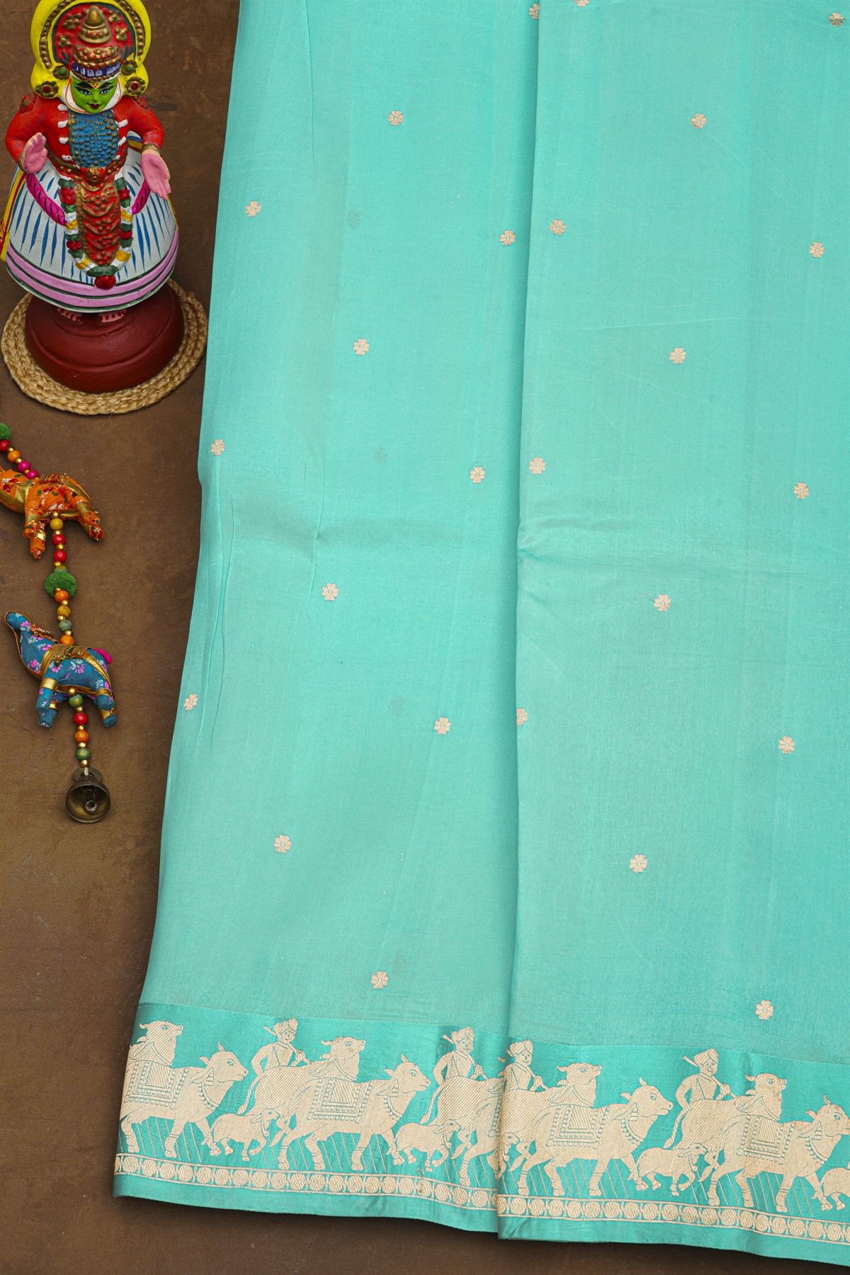 Fancy Matka Silk Sky Blue Saree With Floral Buttis Body And Pichwai Cows Motifs Border
