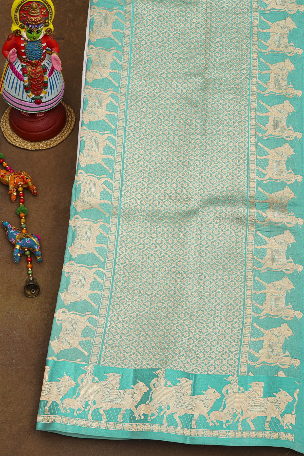 Fancy Matka Silk Sky Blue Saree With Floral Buttis Body And Pichwai Cows Motifs Border