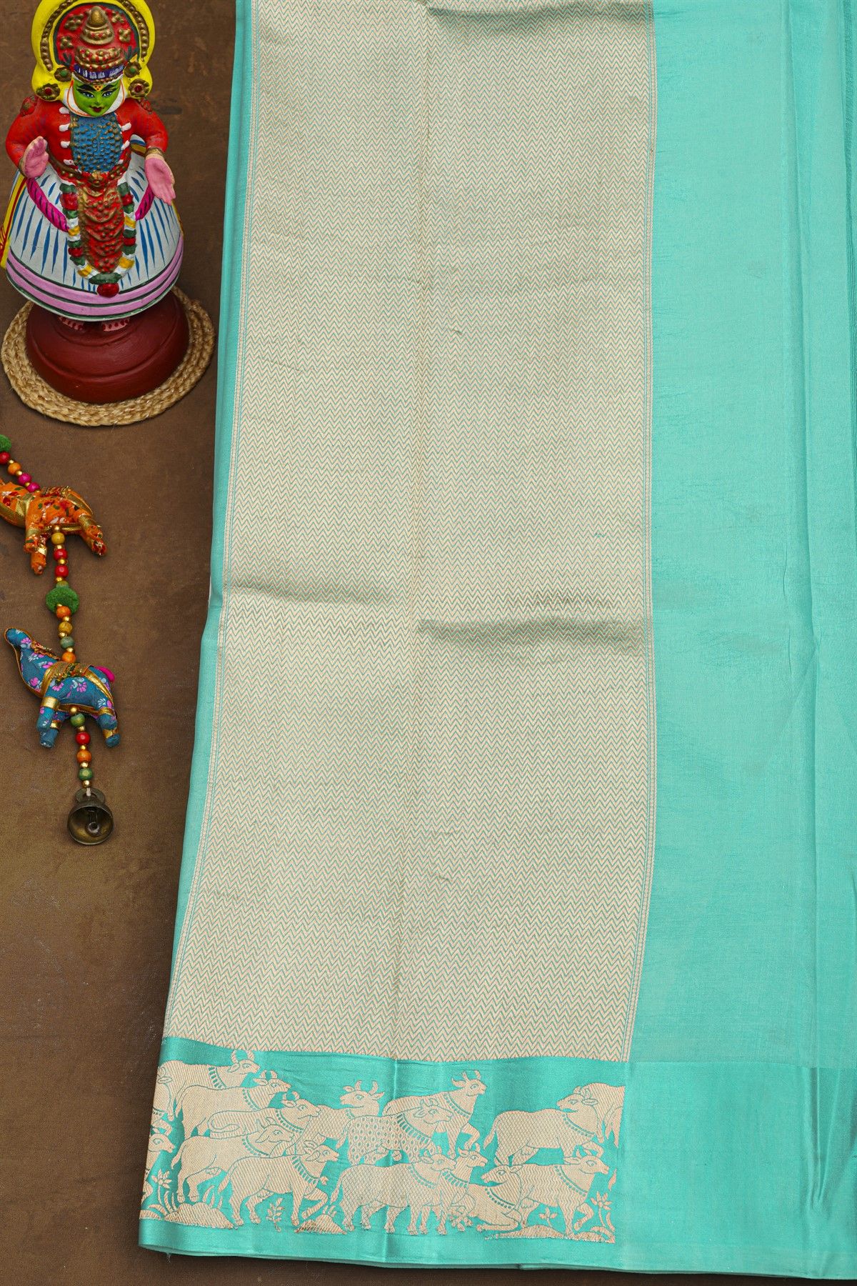 Fancy Matka Silk Sky Blue Saree With Floral Buttis Body And Pichwai Cows Motifs Border