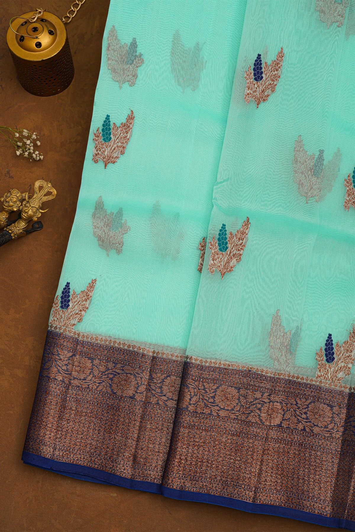 Fancy Organza Sky Blue Saree With Florals And Leaves In Zari Body And Contrast Florals And Leaves Jaal With Diamonds Border