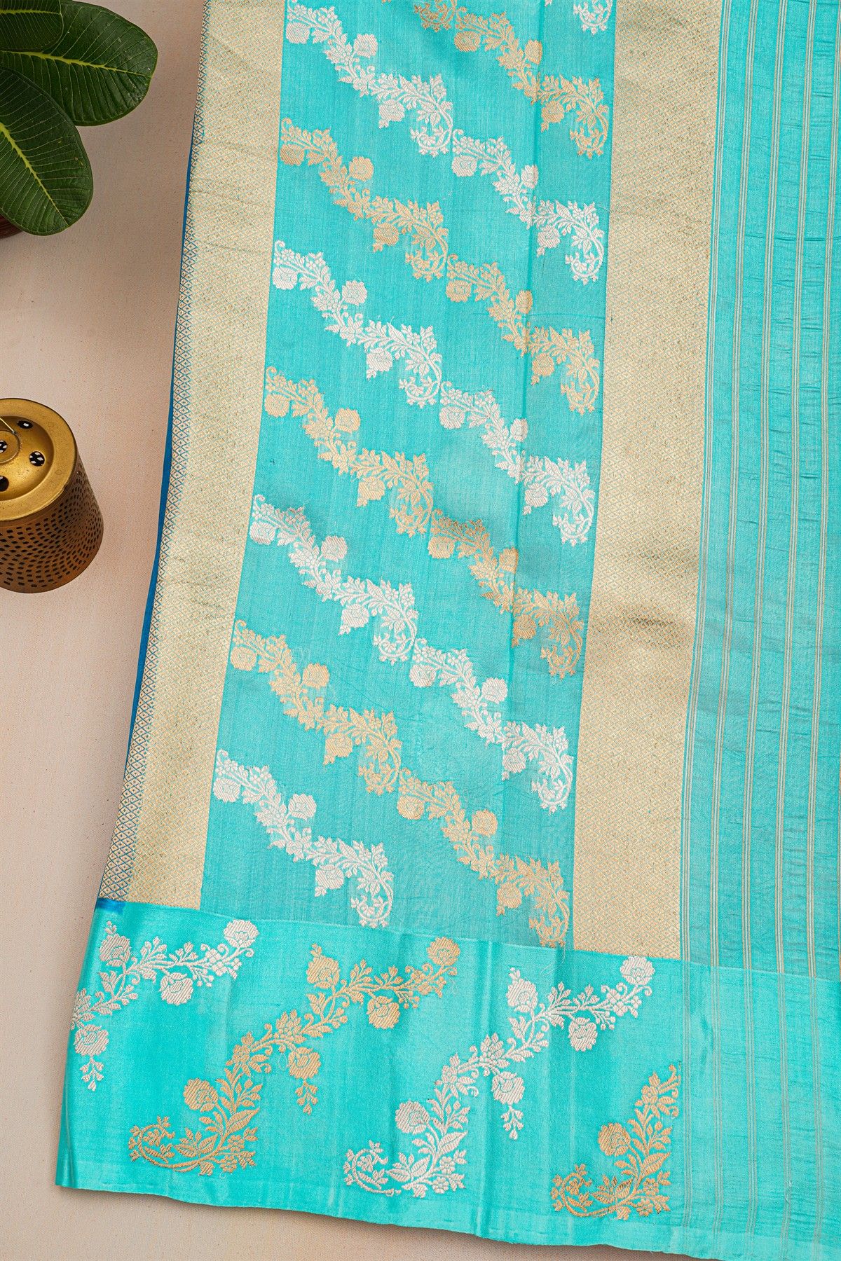 Fancy Matka Silk Peacock Blue Saree With Florals And Buttis Body And Contrast Florals And Leaves Border