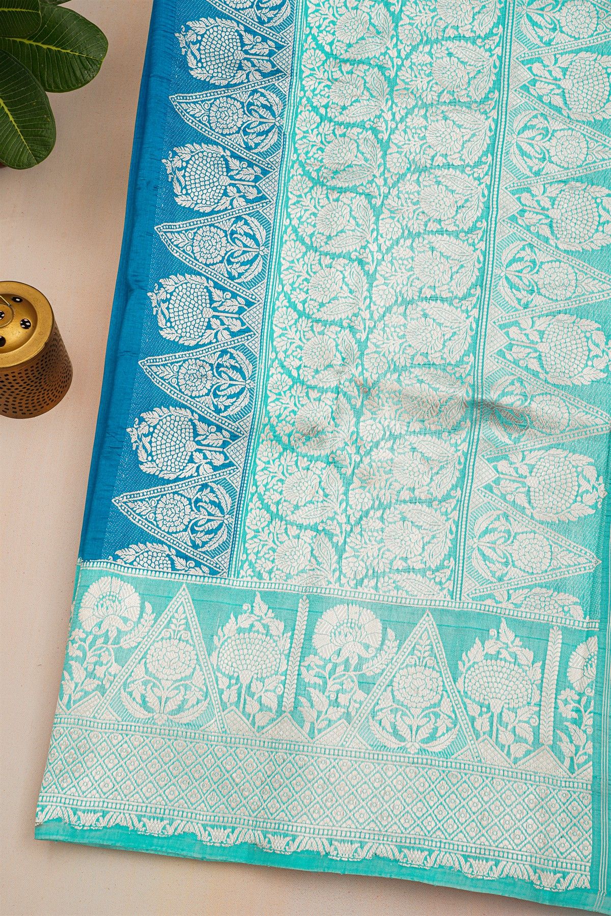 Fancy Matka Silk Peacock Blue Saree With Florals And Buttis Body And Contrast Florals And Leaves Border