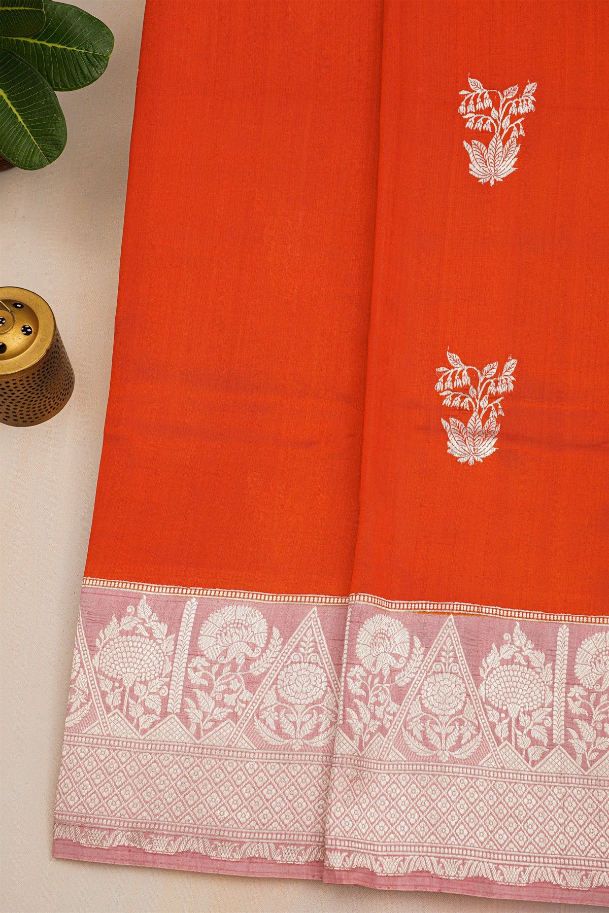 Fancy Matka Silk Orange Saree With Florals And Buttis Body And Contrast Florals And Leaves Border