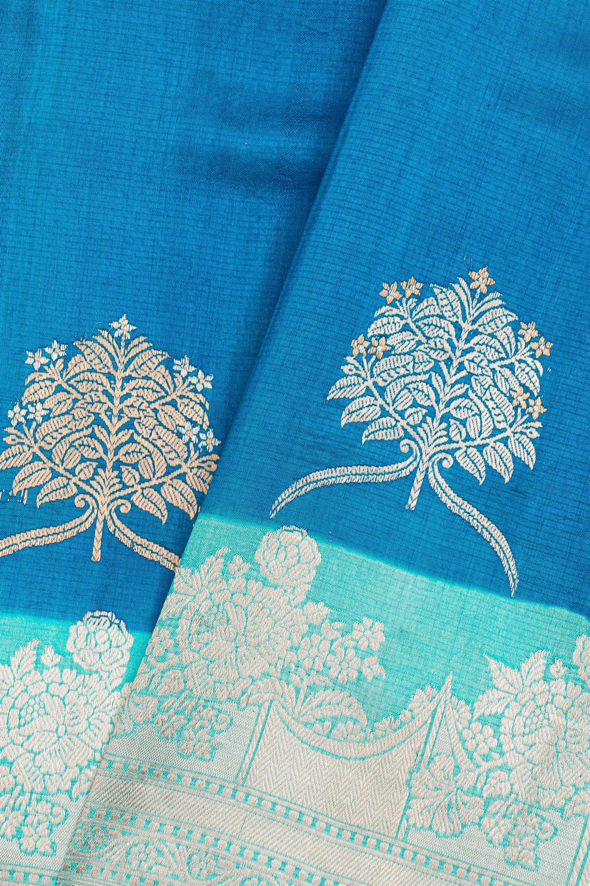 Fancy Matka Silk Royal Blue Saree With Florals And Buttis Body And Contrast Florals And Leaves Border