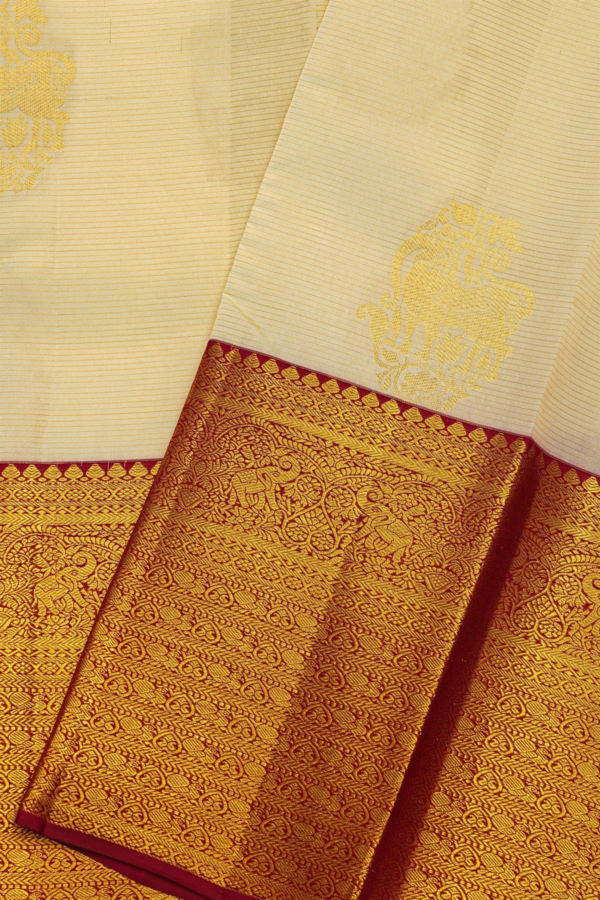 Kancheepuram Silk Cream Saree With Animal Buttis Body And Contrast Florals And Leaves With Animals Border
