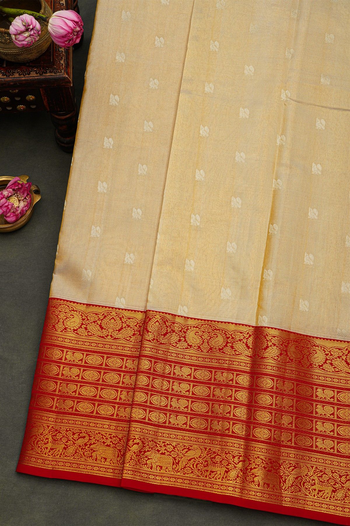 Kancheepuram Silk Cream Saree With Peacock Buttis Body And Contrast Florals And Leaves Border