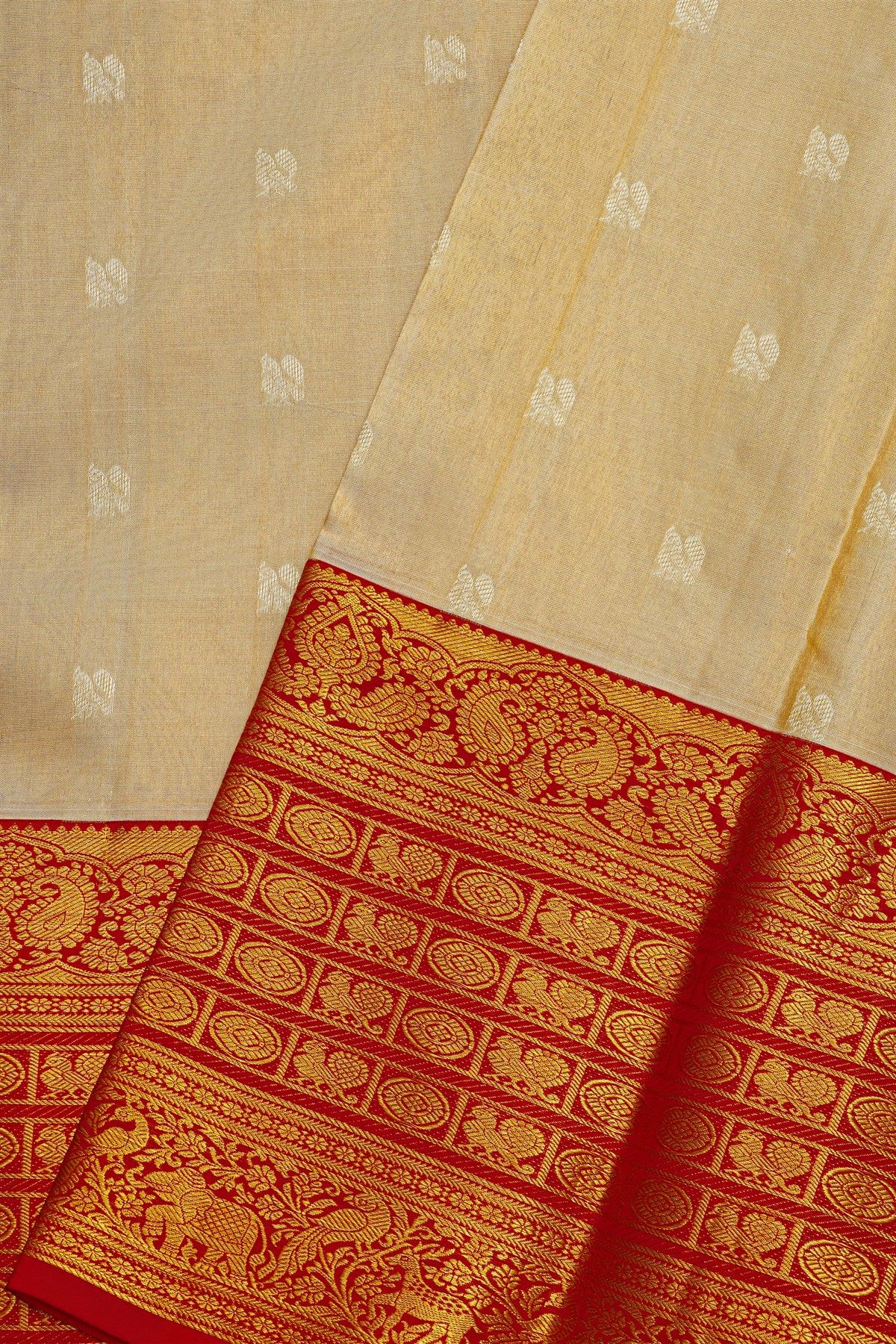 Kancheepuram Silk Cream Saree With Peacock Buttis Body And Contrast Florals And Leaves Border