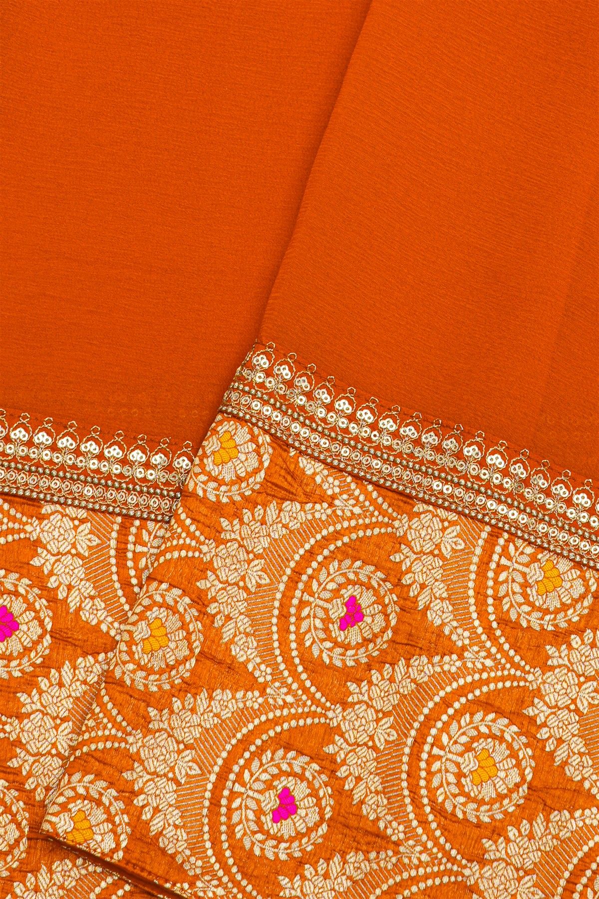 Fancy Crepe Orange Saree With All Over Plain Body And Self Design Florals And Leaves In Zari Border