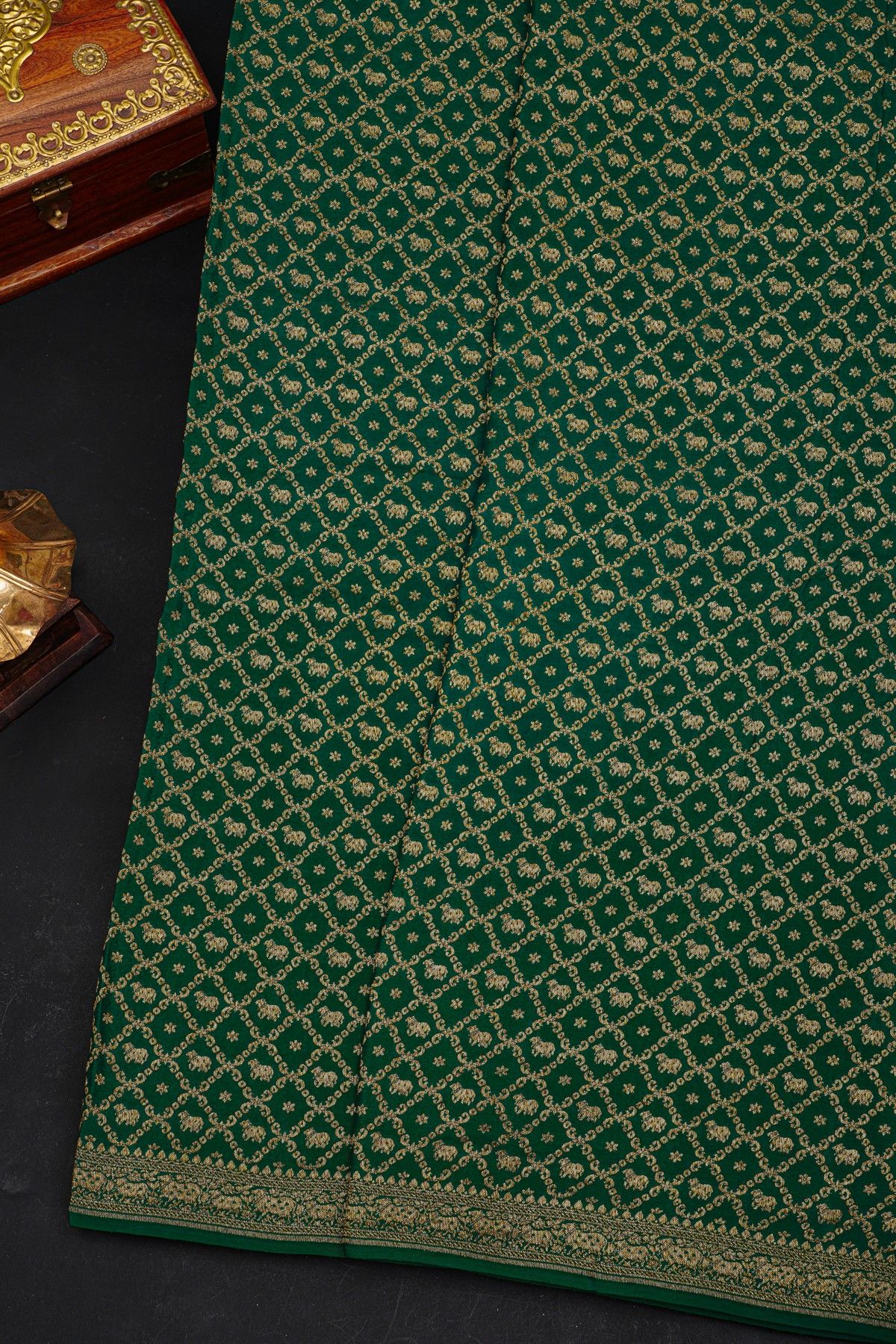 Fancy Georgette Bottle Green Saree With Diamond Grid Zari Jaal And Elephant Buttis Body And Self Florals And Animals Border