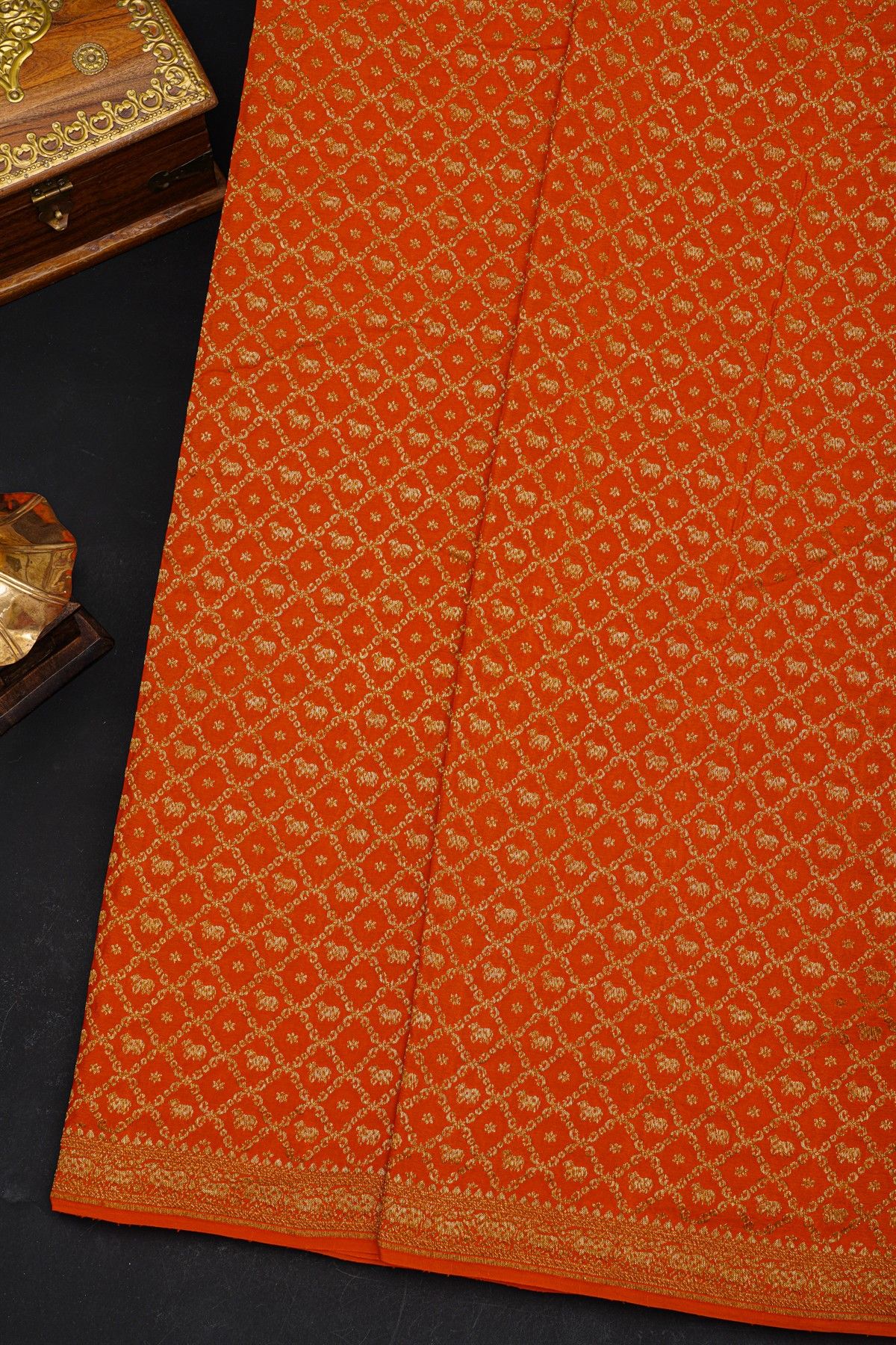 Fancy Georgette Orange Saree With Diamond Grid Zari Jaal And Elephant Buttis Body And Self Florals And Animals Border