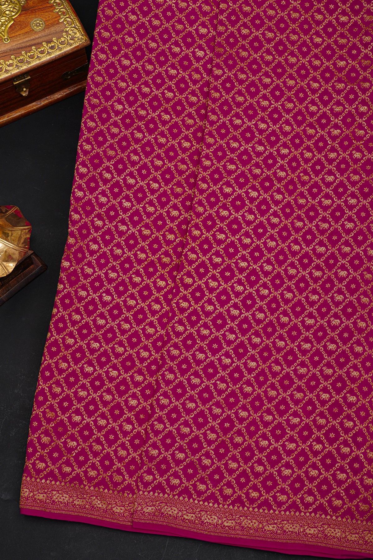 Fancy Georgette Rani Pink Saree With Diamond Grid Zari Jaal And Elephant Buttis Body And Self Florals And Animals Border