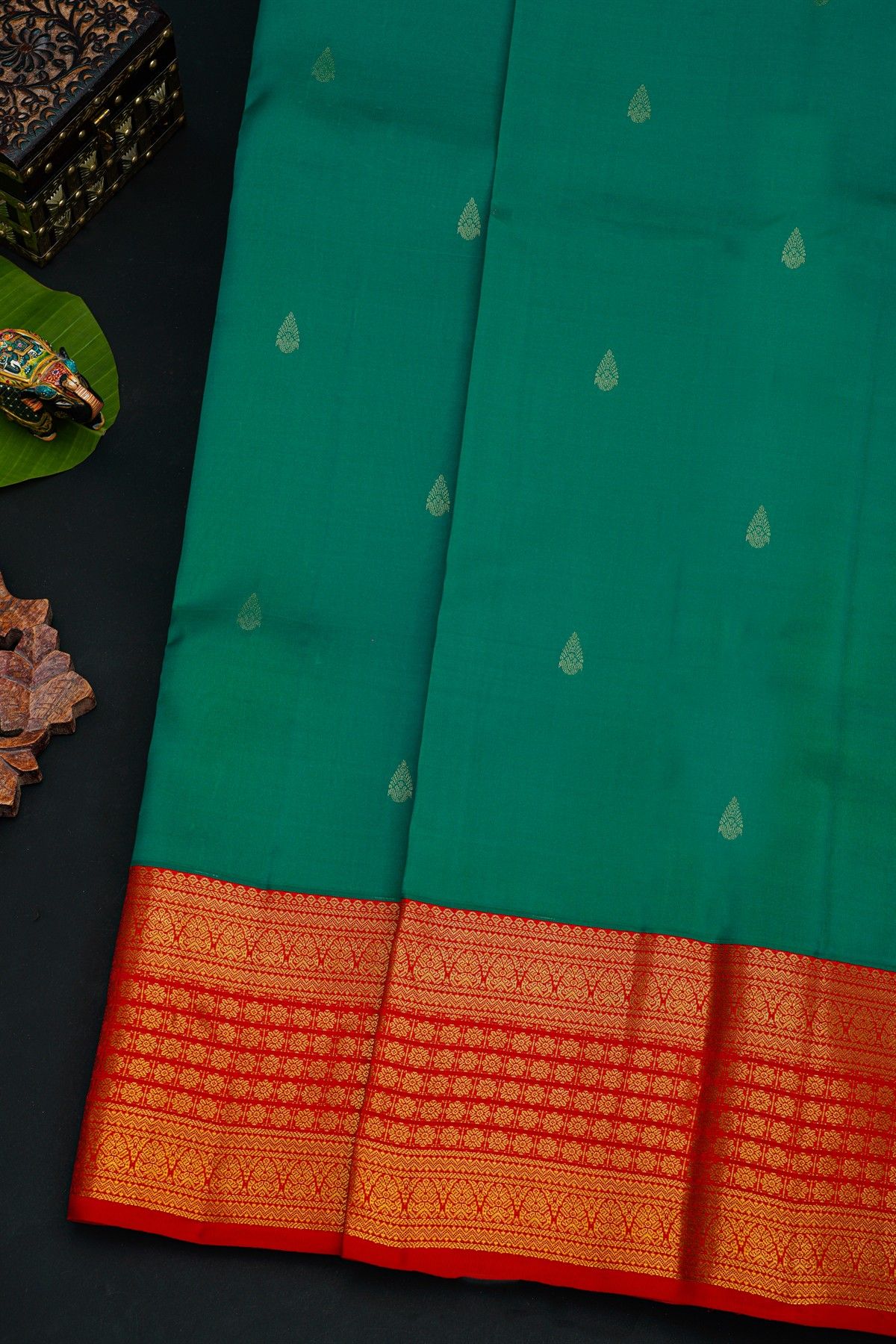 Kancheepuram Silk Peacock Green Saree With Florals And Leaves In Zari Body Red Border