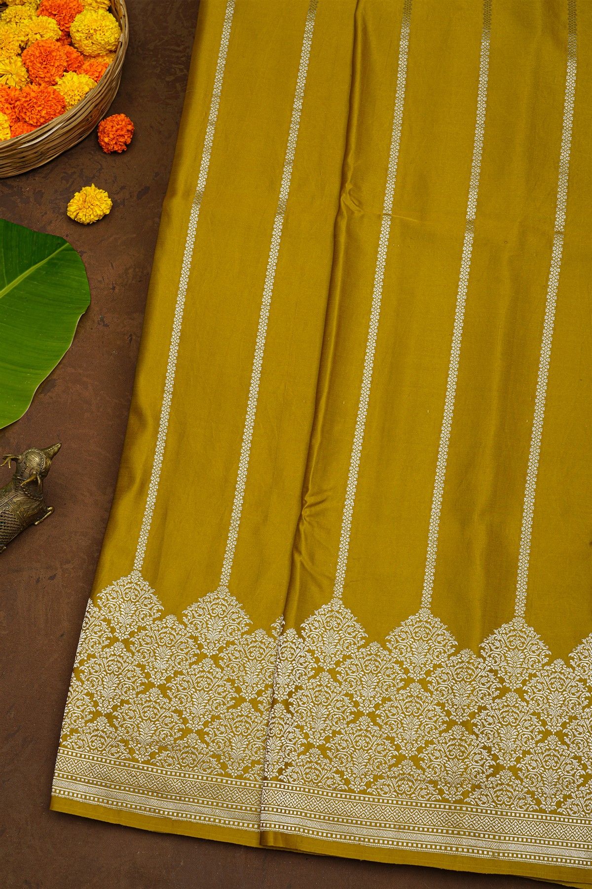 Banarasi Silk Mustard Saree With Zari Lines Body And Self Florals And Leaves Border