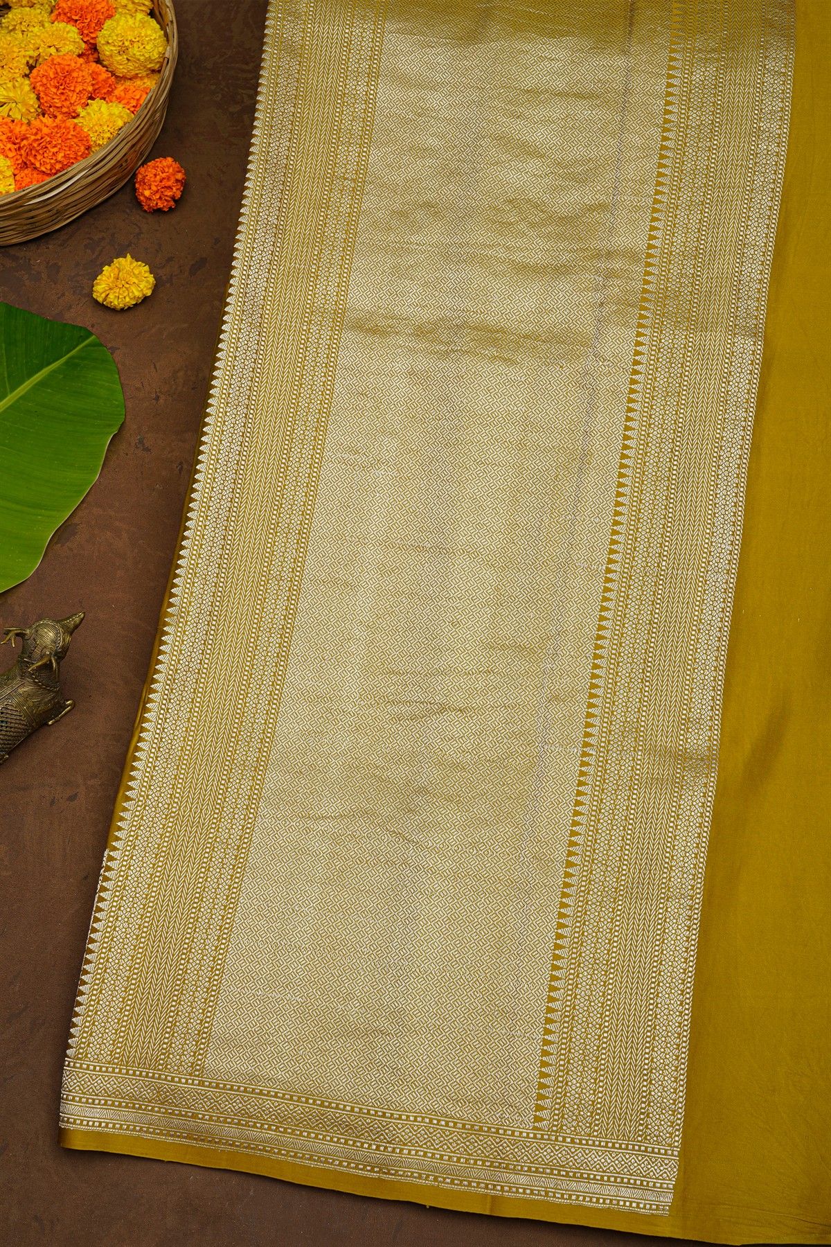 Banarasi Silk Mustard Saree With Zari Lines Body And Self Florals And Leaves Border
