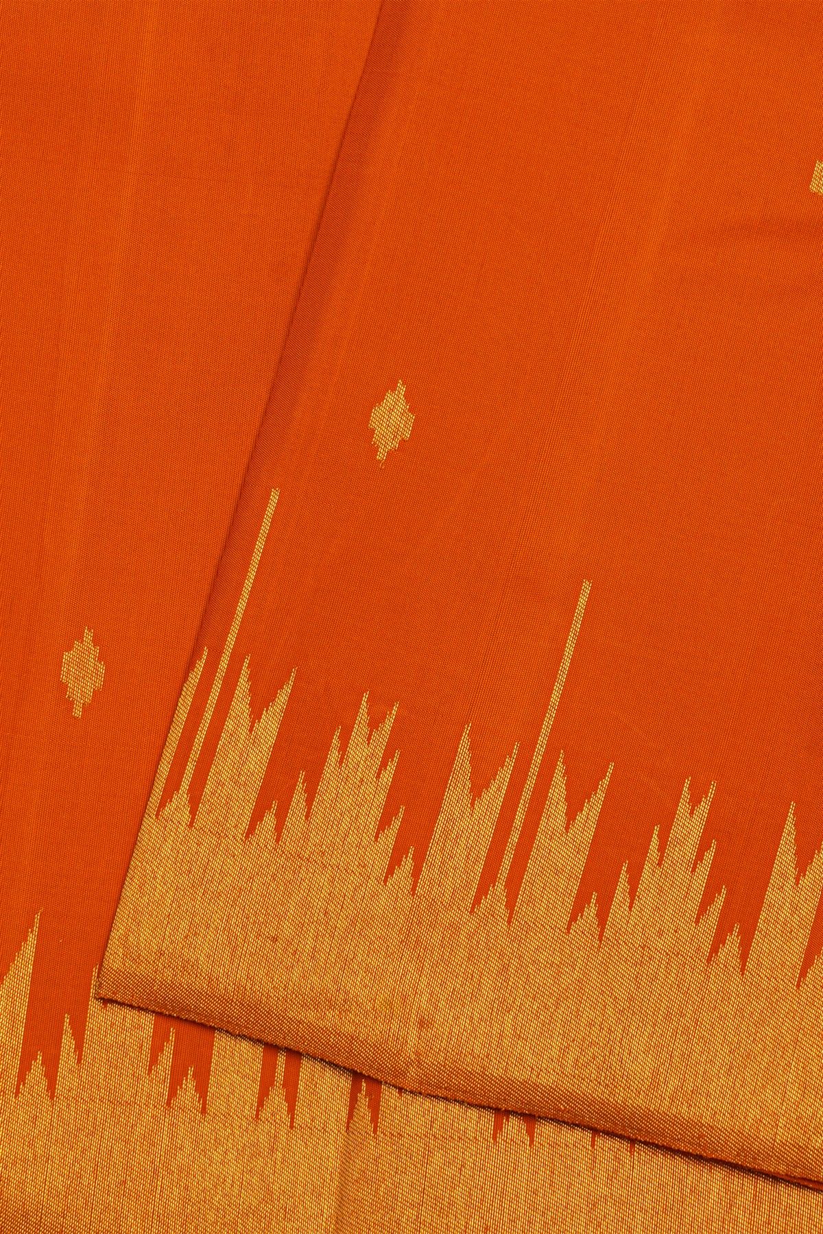 Kancheepuram Silk Rust Saree With Floral Buttis Body And Self Temple Border And Kaddi Pallu