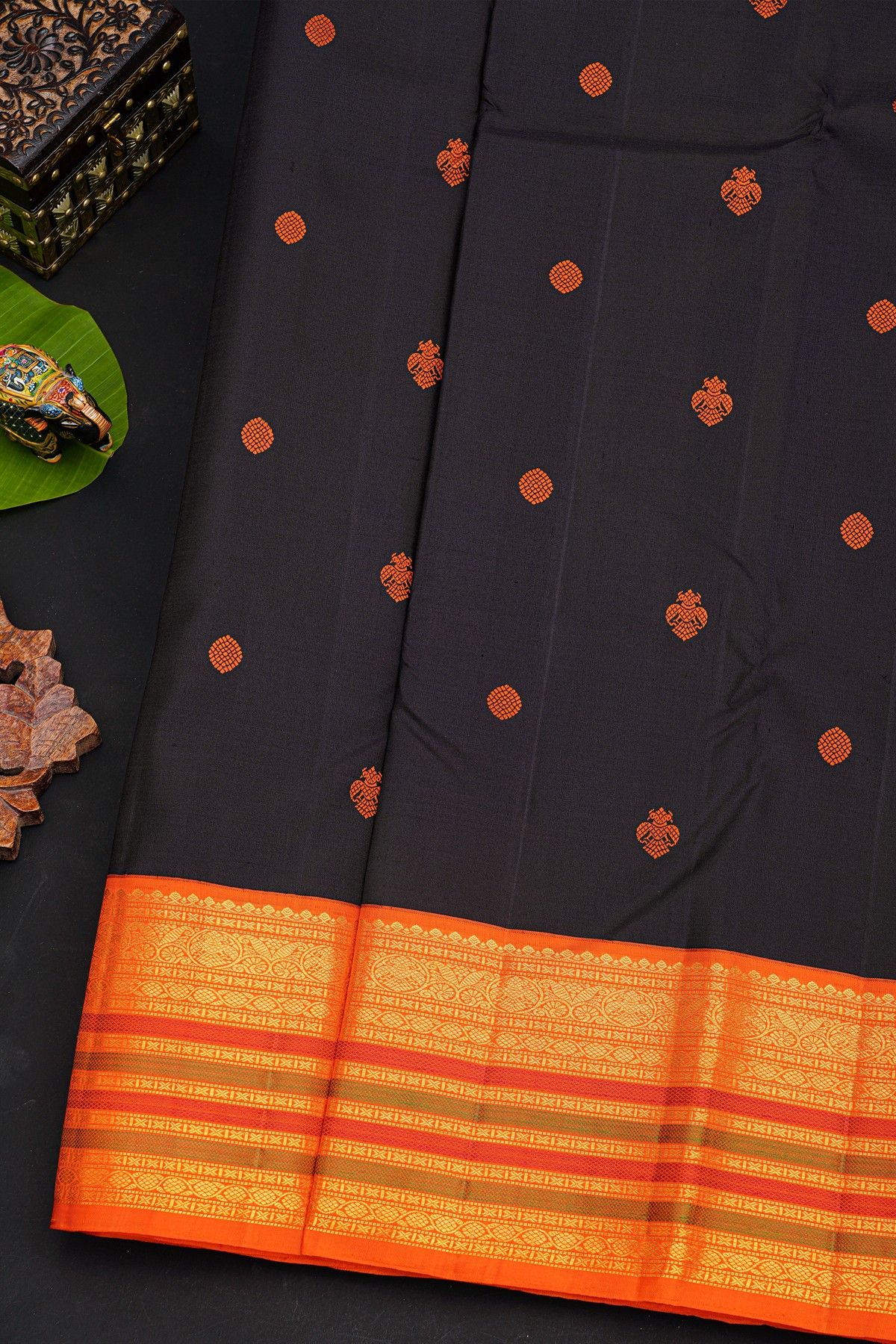 Kancheepuram Silk Black Saree With Orange Buttas And Traditional Zari Border
