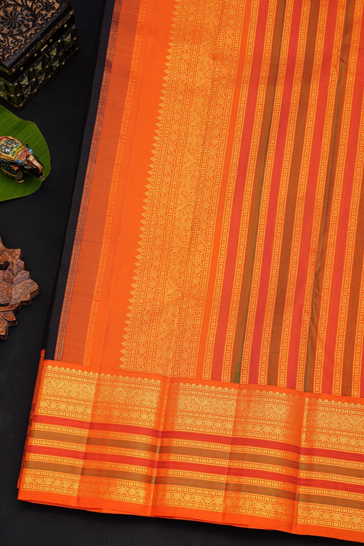 Kancheepuram Silk Black Saree With Orange Buttas And Traditional Zari Border