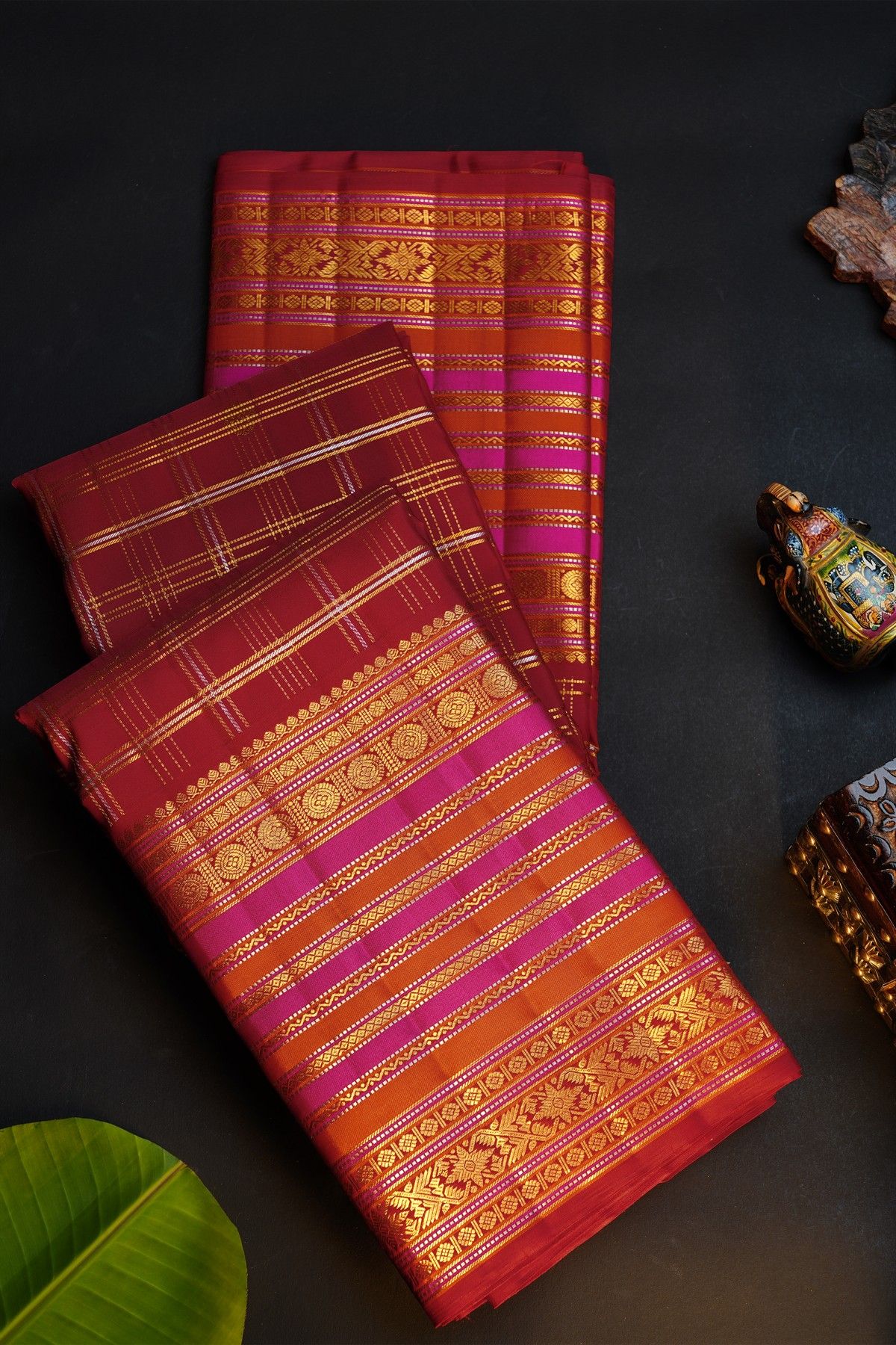 Kancheepuram Silk Maroon Saree With Florals And Peacocks In Checks Body And Self Zig-Zag Lines And Florals Border