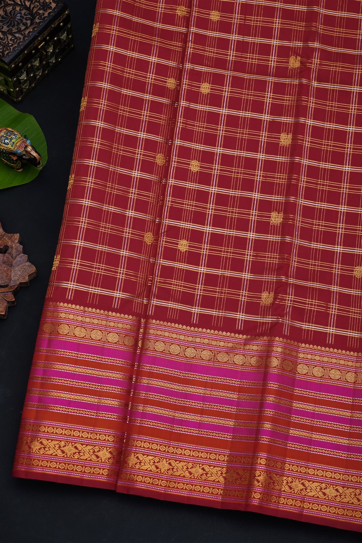 Kancheepuram Silk Maroon Saree With Florals And Peacocks In Checks Body And Self Zig-Zag Lines And Florals Border