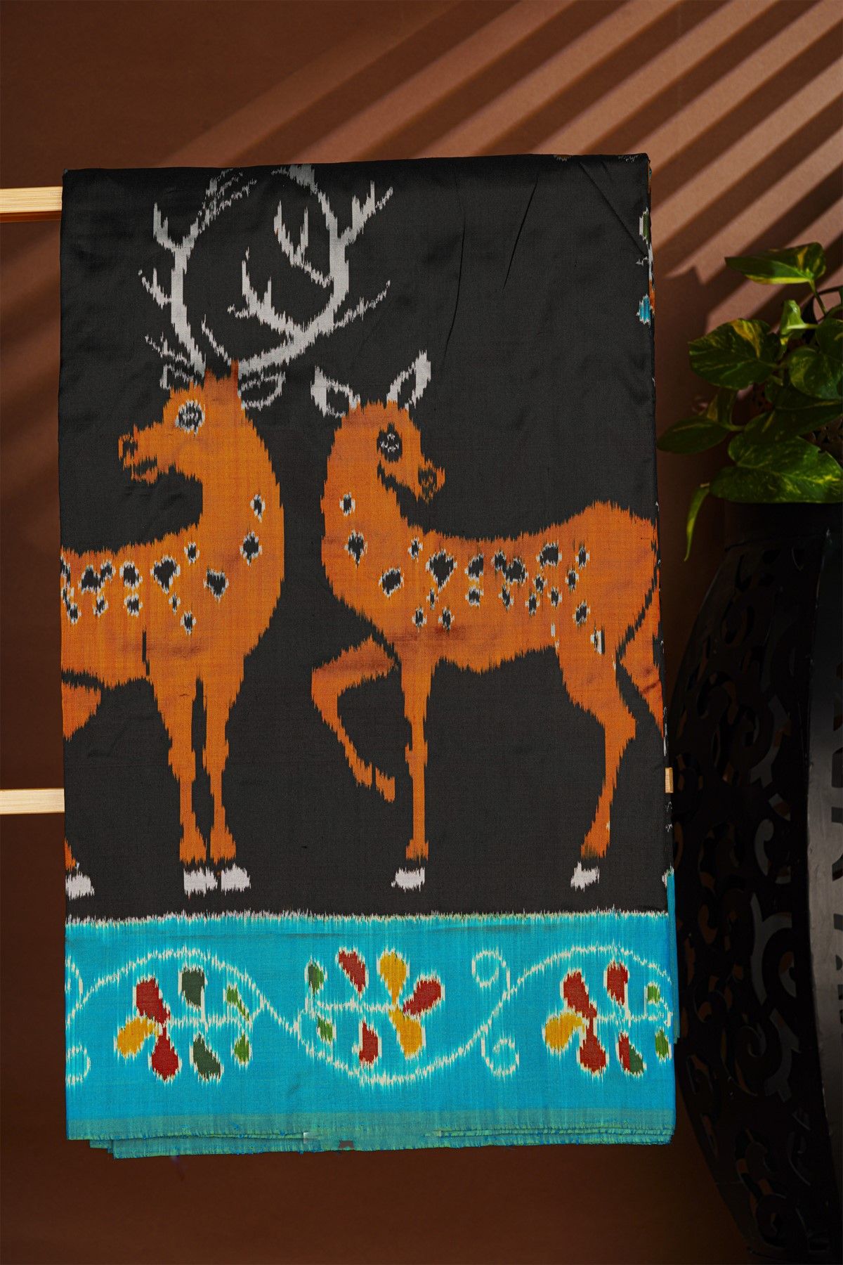 Ikat Silk Black Saree With Florals And Deers In Ikat Design Body