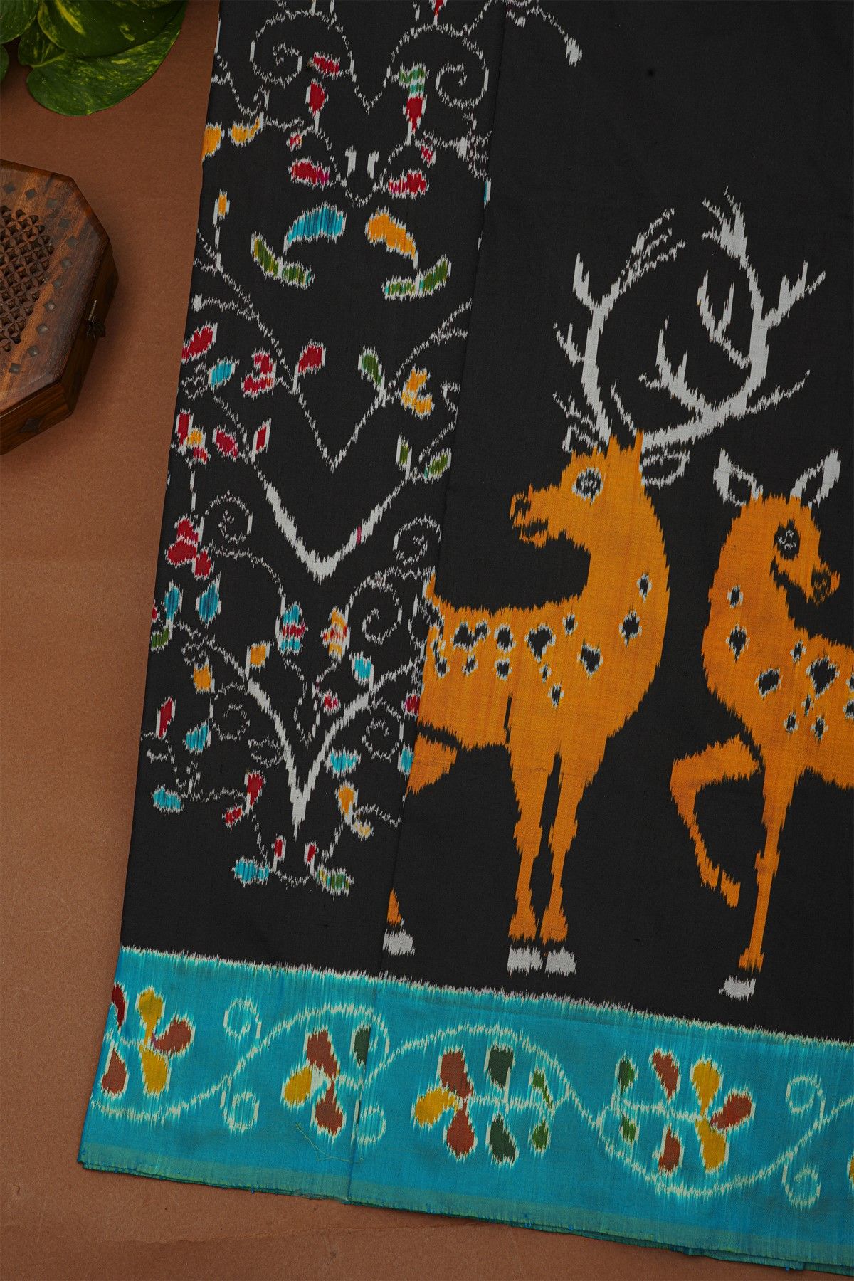 Ikat Silk Black Saree With Florals And Deers In Ikat Design Body
