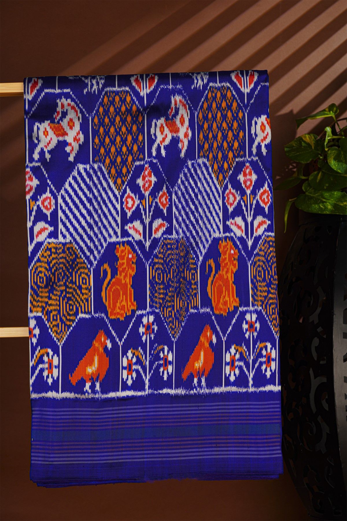 Ikat Silk Royal Blue Saree With Multicolor Floral Animal Motifs And Striped Border