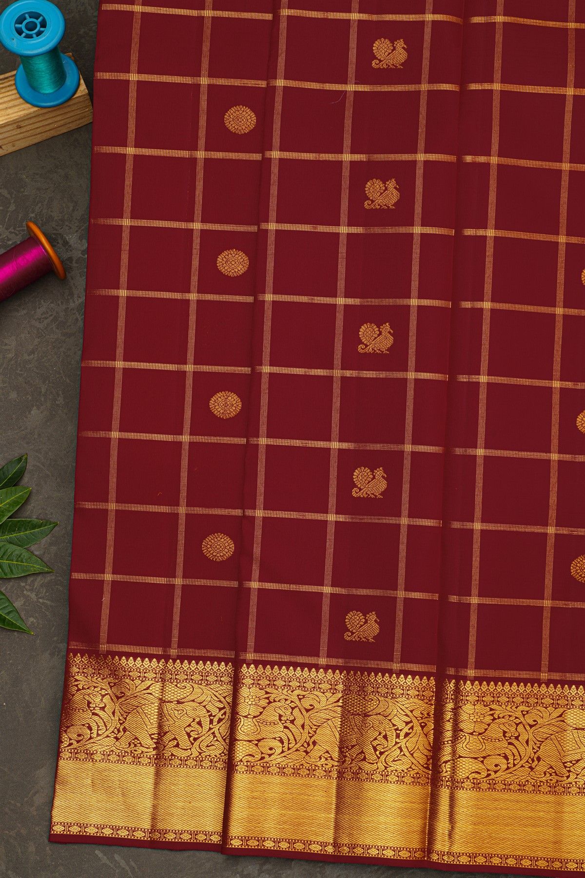 Kancheepuram Silk Dark Maroon Saree With Zari Checks Floral And Peacock Buttis Body