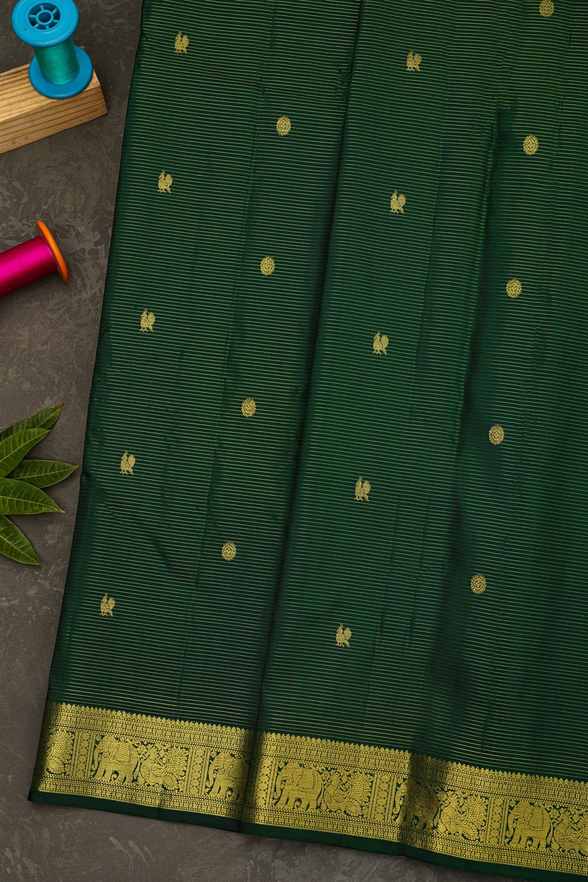 Kancheepuram Silk Bottle Green Saree With Zari Lines Checks Florals And Peacock Buttis Body