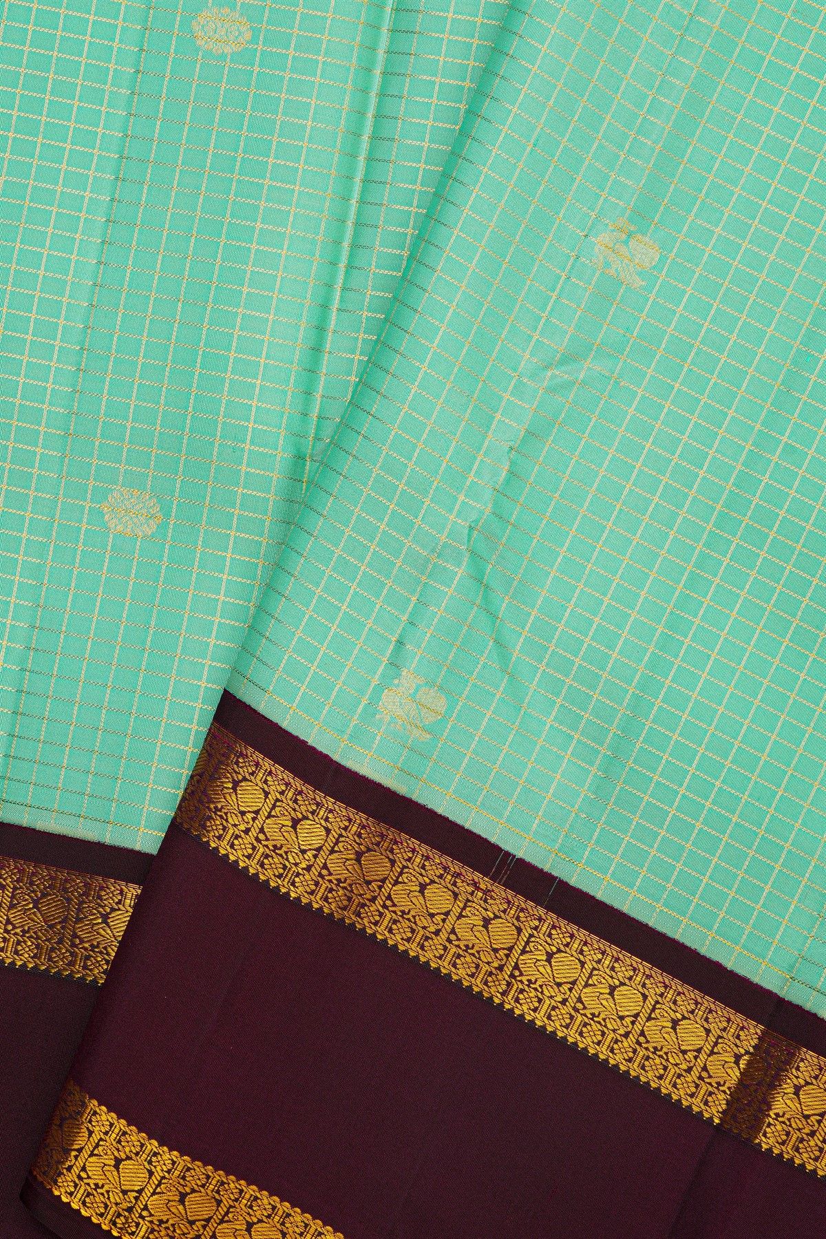 Kancheepuram Silk Sky Blue Saree With Zari Checks And Floral Buttis Body And Gap Border