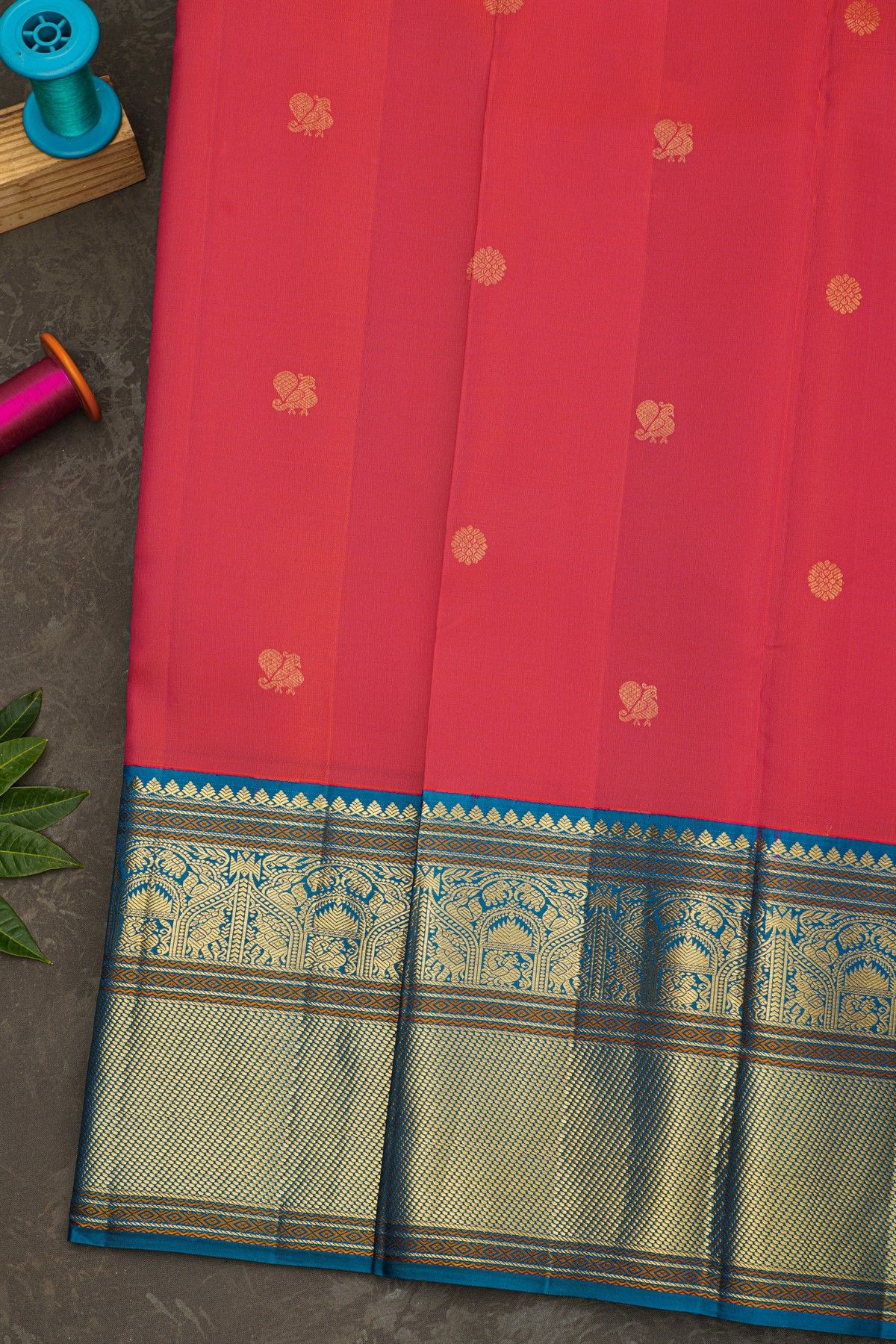 Kancheepuram Silk Coral Saree With Florals And Peacock Buttis Body