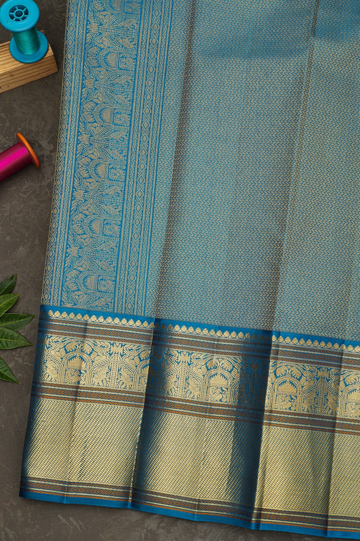 Kancheepuram Silk Coral Saree With Florals And Peacock Buttis Body