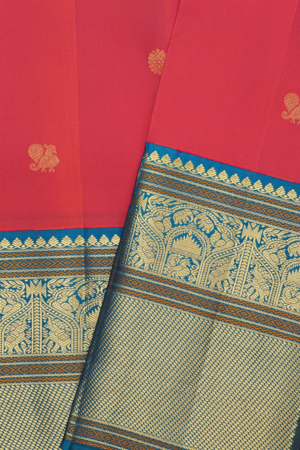 Kancheepuram Silk Coral Saree With Florals And Peacock Buttis Body