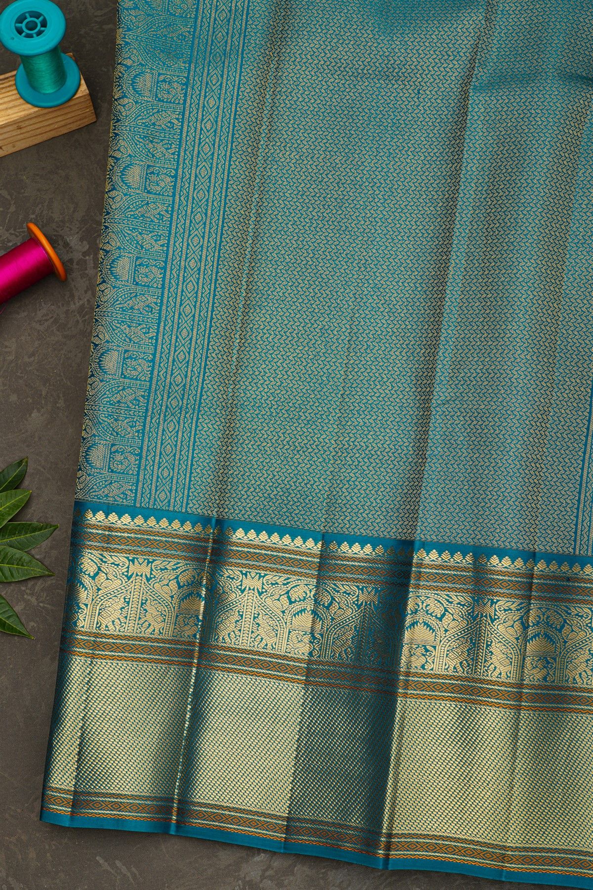 Kancheepuram Silk Sky Blue Saree With Florals And Peacock Buttis Body