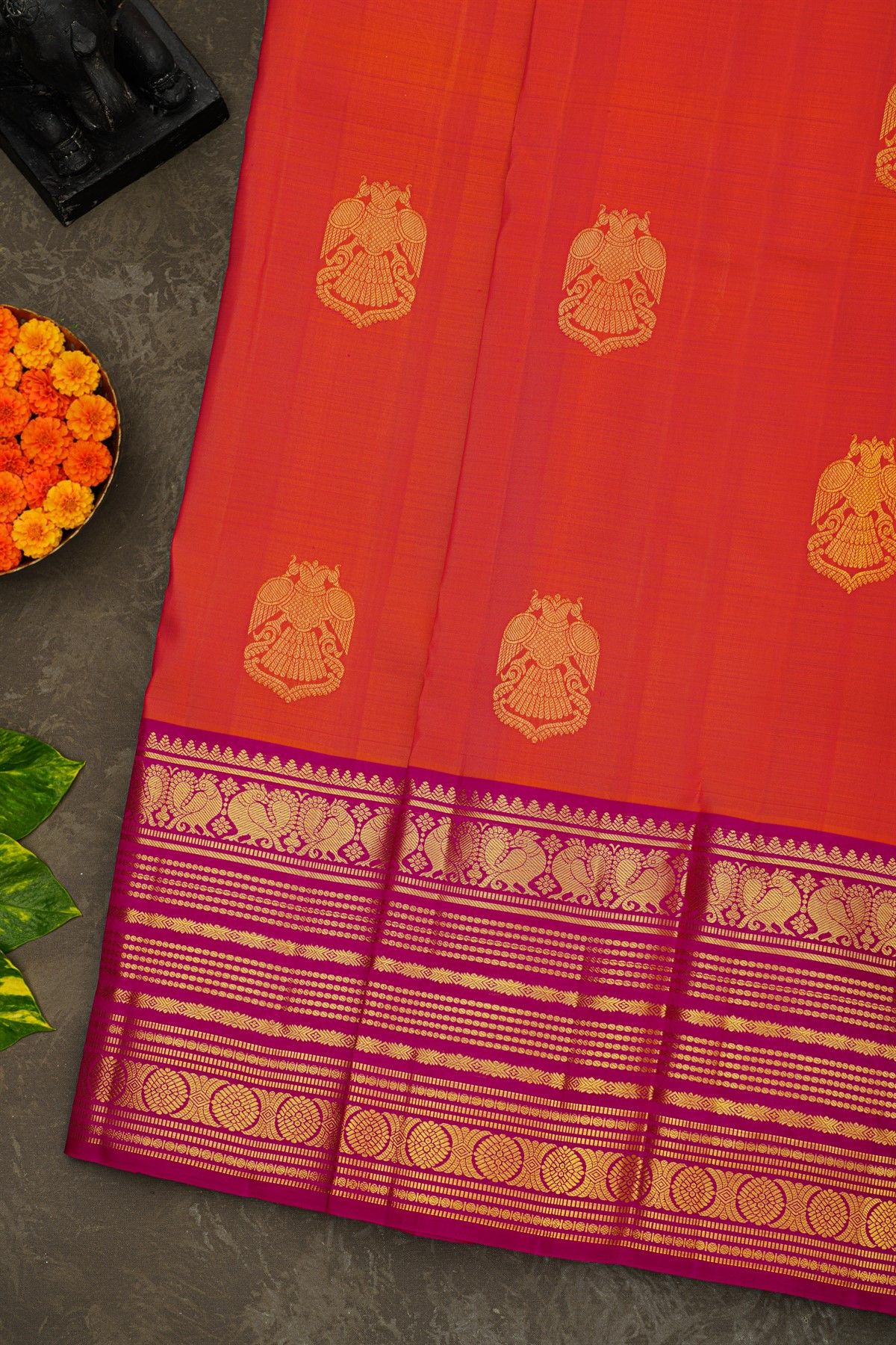 Kancheepuram Silk Orange Saree With Florals And Peacocks Buttis Border