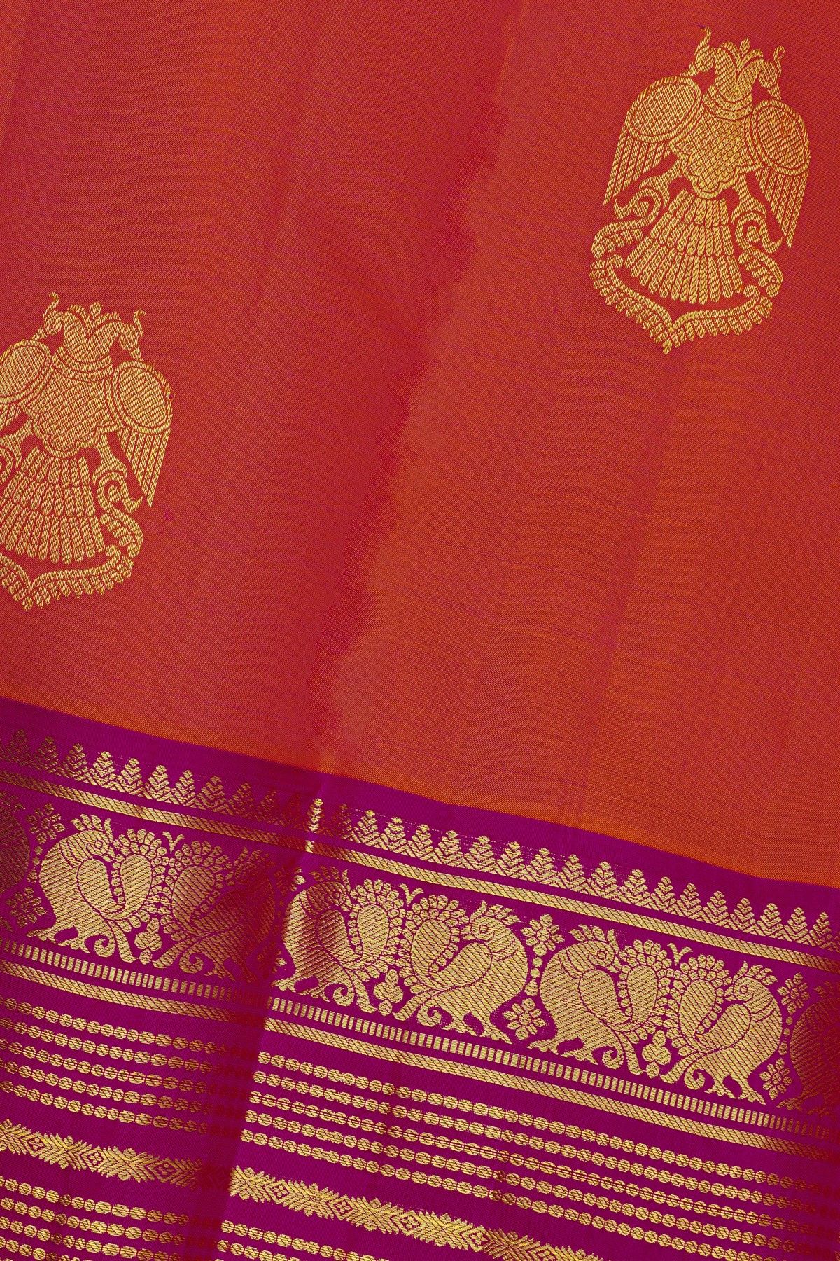 Kancheepuram Silk Orange Saree With Florals And Peacocks Buttis Border