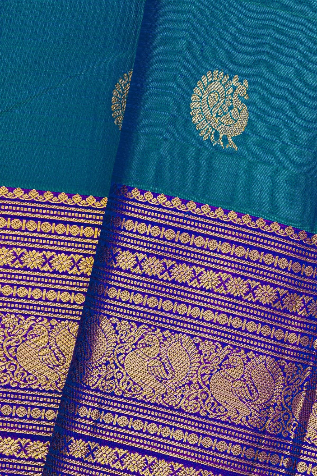 Kancheepuram Silk Blue Saree With Florals And Peacocks In Zari Body And Long Border