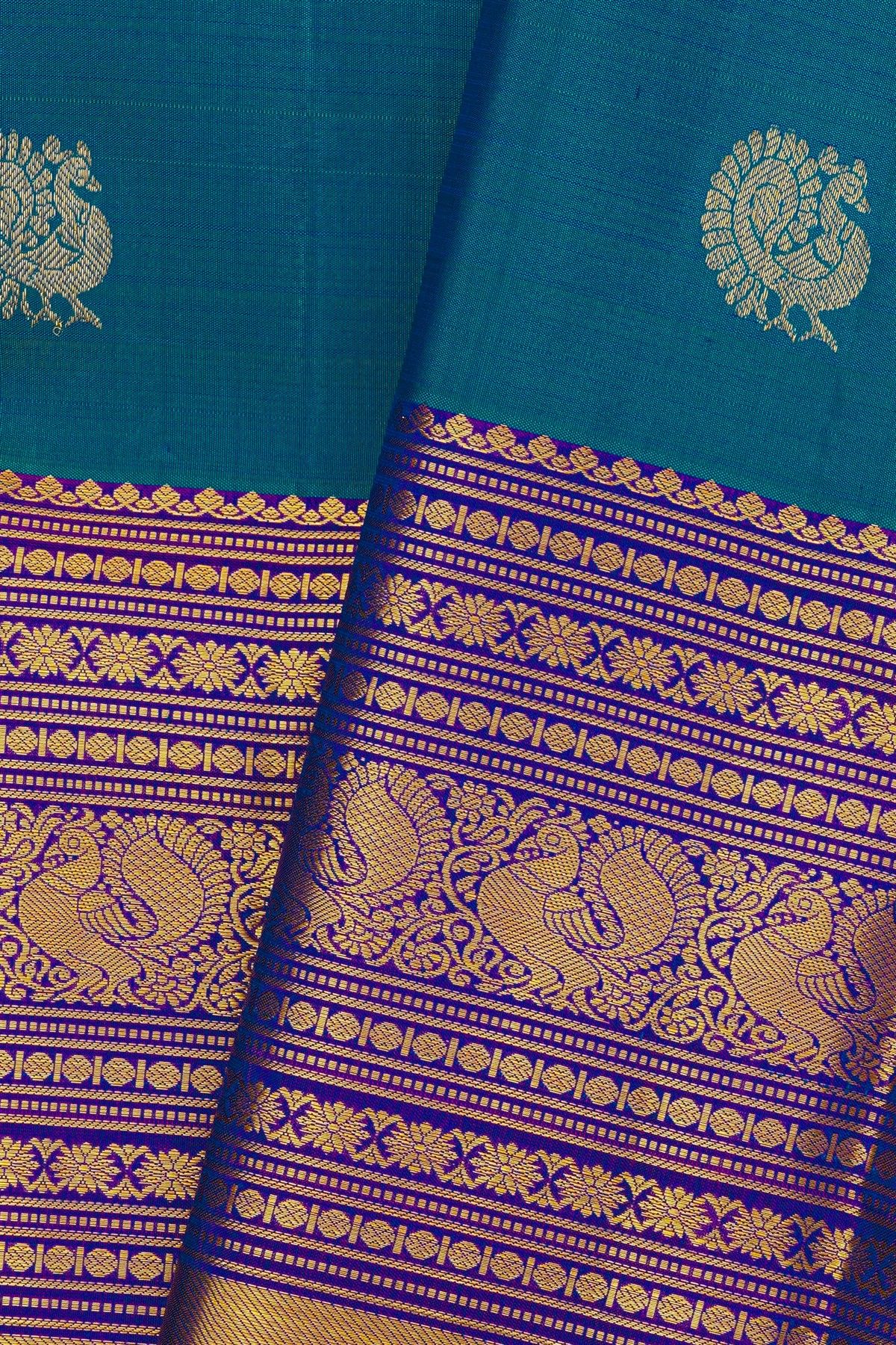 Kancheepuram Silk Blue Saree With Florals And Peacock Buttis In Zari Body