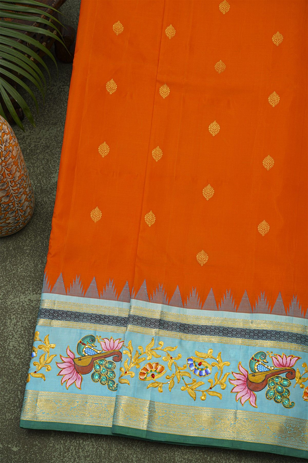 Gadwal Silk Orange Saree With Tanjore Hand-Painted Veena Peacock & Floral Zari Border