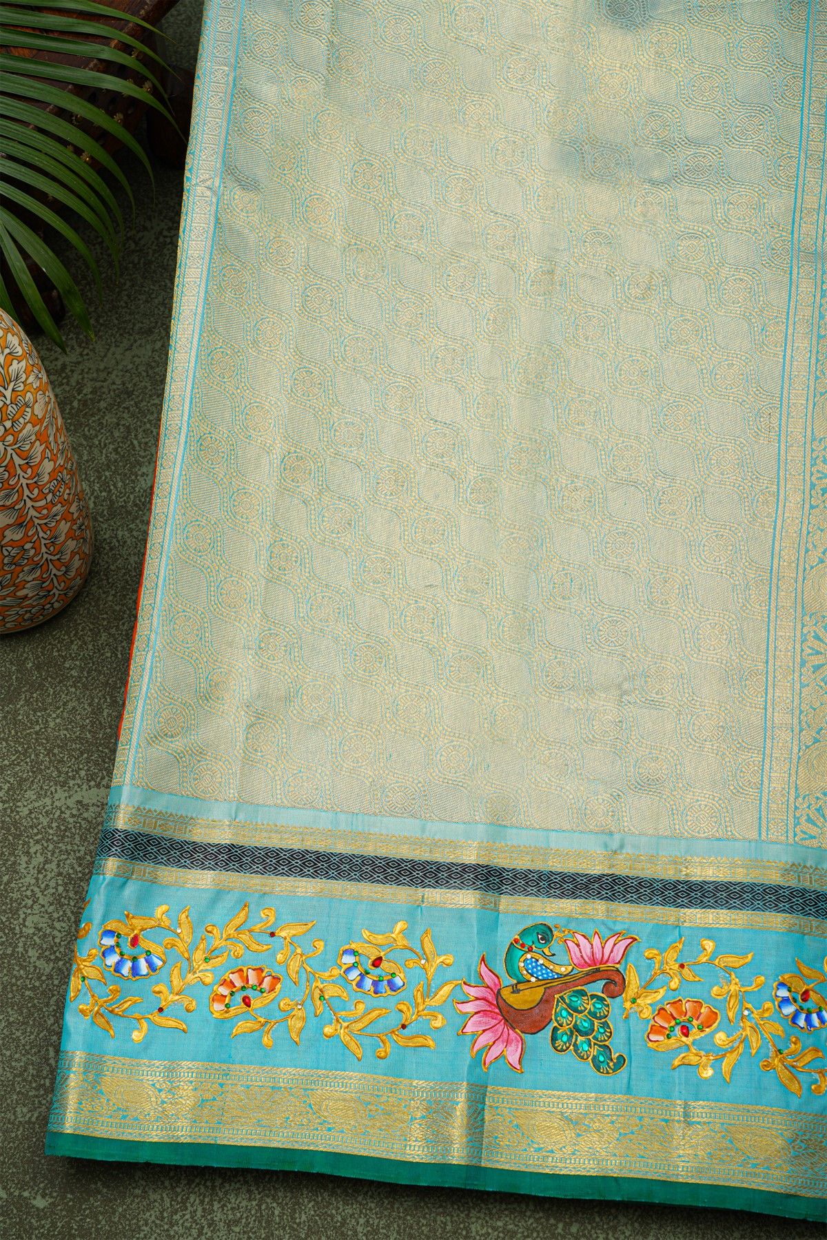 Gadwal Silk Orange Saree With Tanjore Hand-Painted Veena Peacock & Floral Zari Border