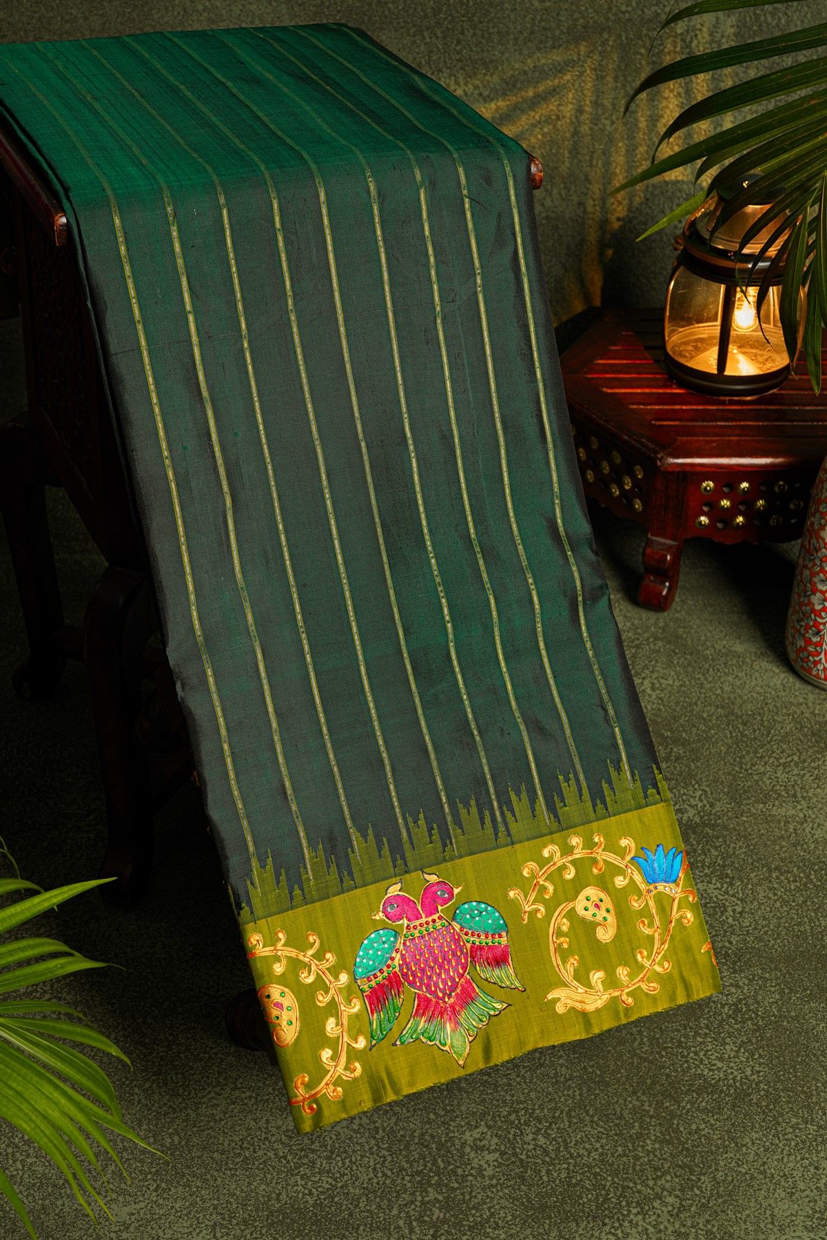 Gadwal Silk Bottle Green Saree With Tanjore Hand-Painted Florals And Gandaberunda Border