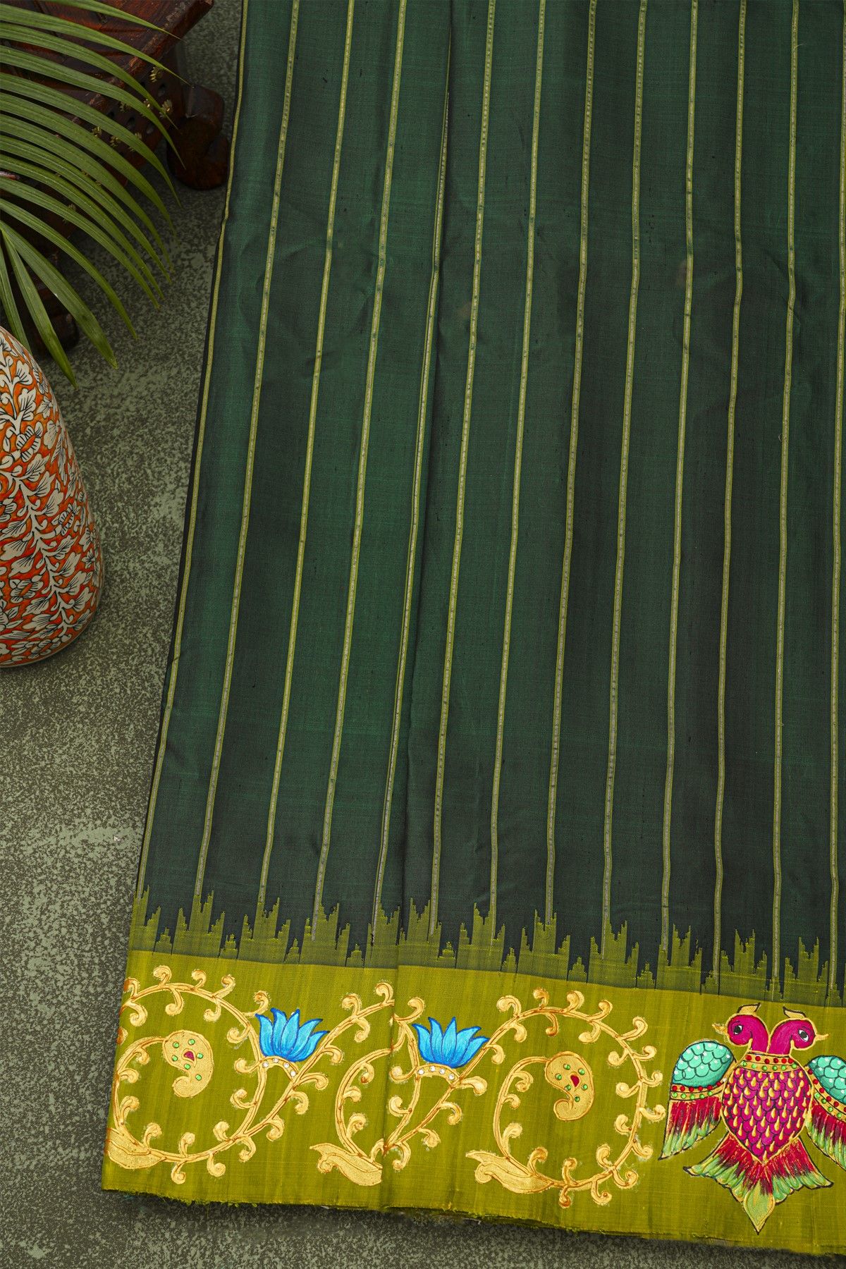 Gadwal Silk Bottle Green Saree With Tanjore Hand-Painted Florals And Gandaberunda Border