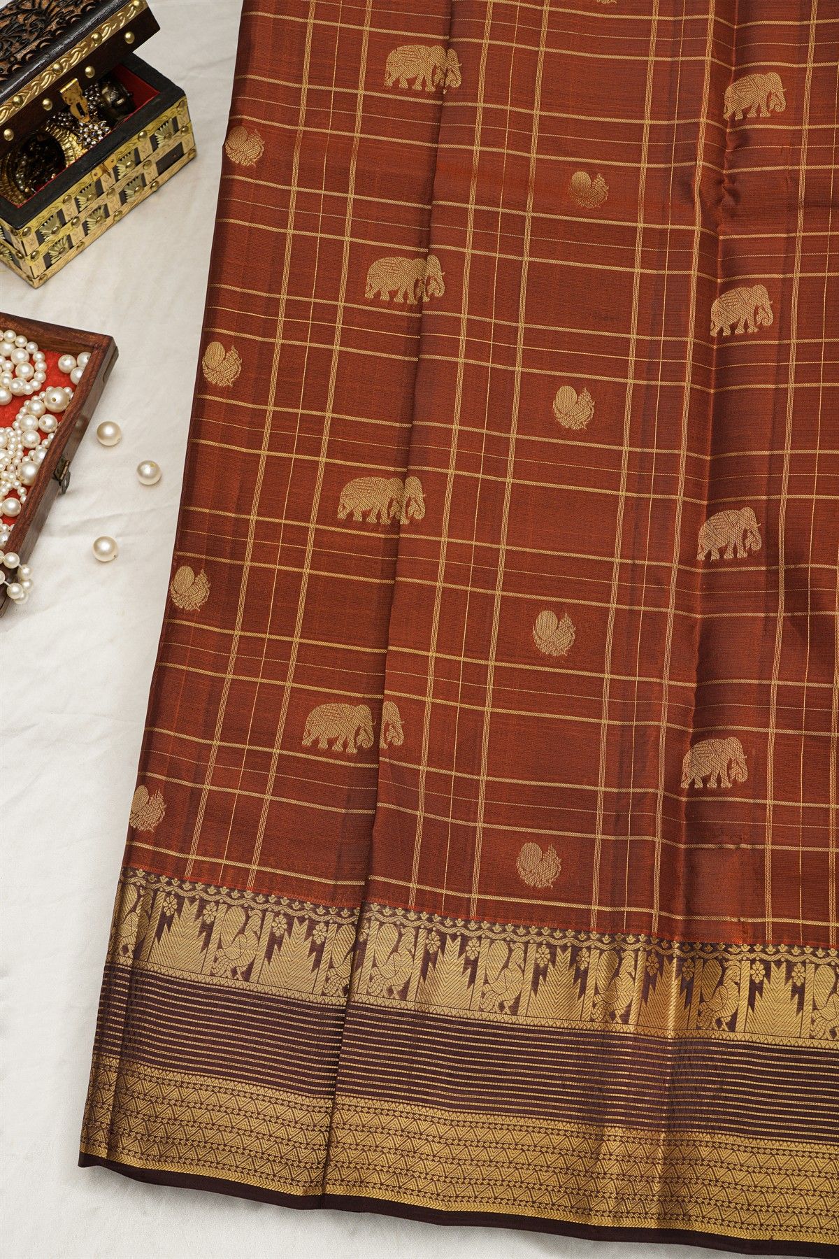 Kancheepuram Silk Rust Saree With Checks And Traditional Border