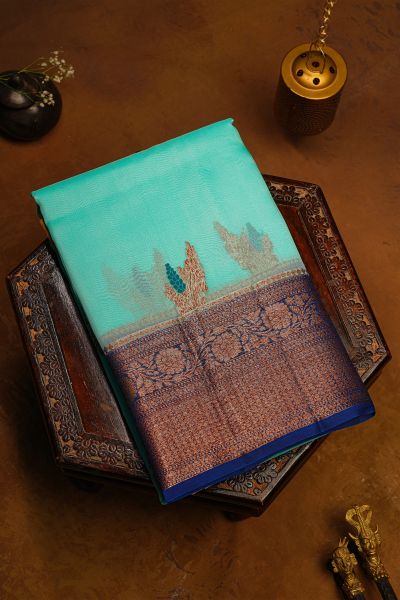 Fancy Organza Sky Blue Saree With Florals And Leaves In Zari Body And Contrast Florals And Leaves Jaal With Diamonds Border