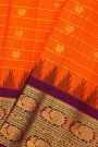Gadwal Silk Orange Saree With Florals And Peacocks Border