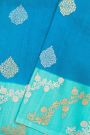 Fancy Matka Silk Peacock Blue Saree With Florals And Buttis Body And Contrast Florals And Leaves Border