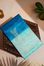 Fancy Matka Silk Peacock Blue Saree With Florals And Buttis Body And Contrast Florals And Leaves Border