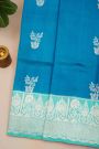 Fancy Matka Silk Peacock Blue Saree With Florals And Buttis Body And Contrast Florals And Leaves Border