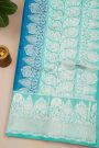Fancy Matka Silk Peacock Blue Saree With Florals And Buttis Body And Contrast Florals And Leaves Border